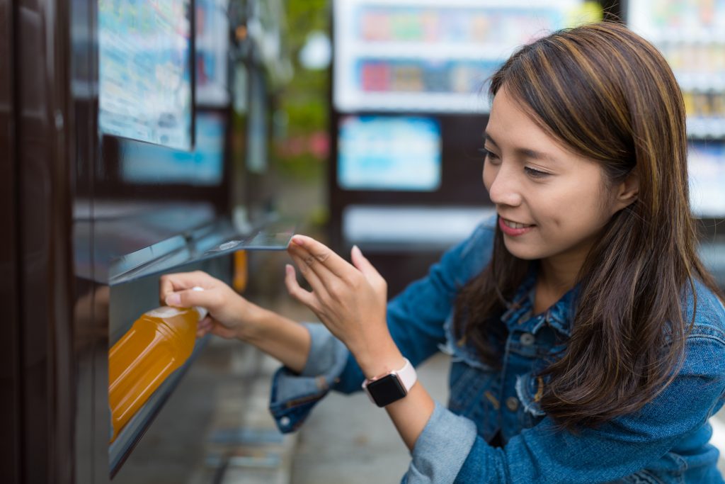 Person buying a drink from a vending machine